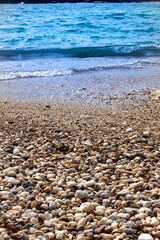 Sea wave, sand and pebbles