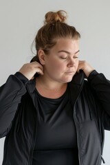 studio shot on whitewoman. dressed in minimalistic athleisure wear with no visible logos. 