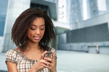 Happy confident business woman using mobile phone