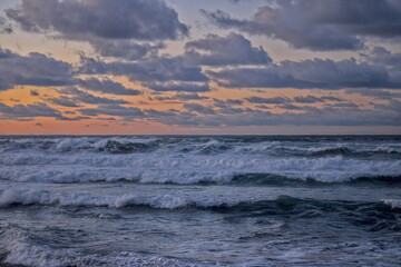 sunset over the waving ocean