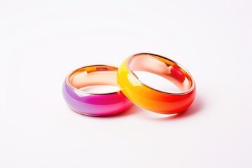 Two wedding rings with rainbow colors on a pure white background, symbolizing LGBT unions. LGBT Wedding Rings on White