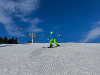 Happy kid in dynamic ski slope moment at alpine mountain resort - 773066651