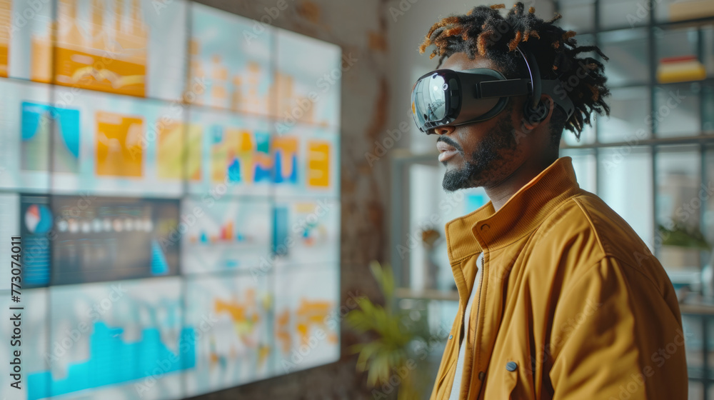Poster a focused man wearing virtual reality glasses is interacting with futuristic data on a transparent d