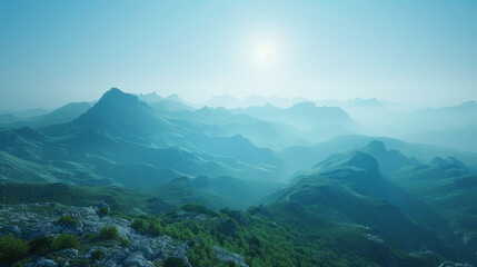 Misty mountain landscape at sunrise with layers of blue ridge mountains and soft sunlight penetrating the haze.