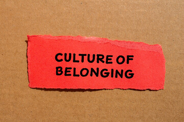 Culture of belonging words written on red torn paper with cardboard background. Conceptual business symbol. Copy space.