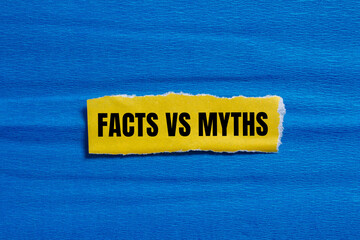 Facts vs myths words written on yellow torn paper with blue background. Conceptual symbol. Copy...