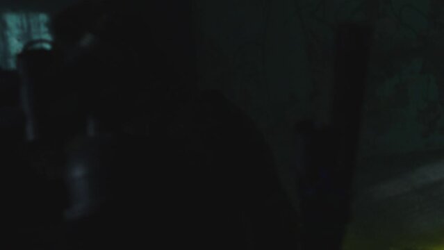 A soldier in a mask enters a dark room