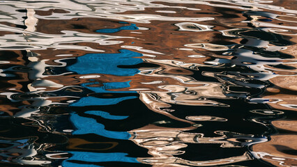 Liquid art. Multicolored reflections and highlights on the surface of sea water in sunny day....