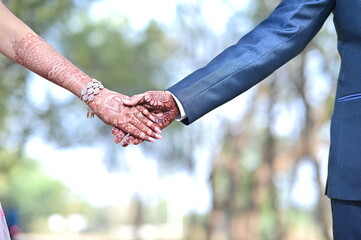 two hands holding each other. bride and groom hands. engaged. Hands of the couple.