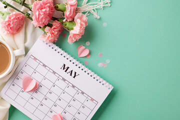Mother’s Day moments: A serene composition featuring a calendar, ribboned gift, and carnations...
