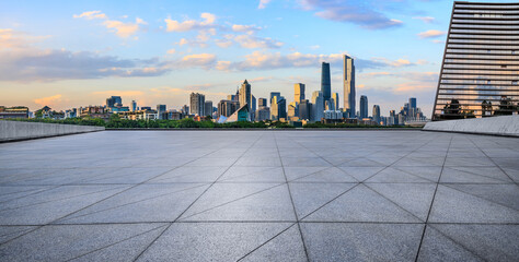 Empty square floors and modern city buildings scenery at sunset. Panoramic view.