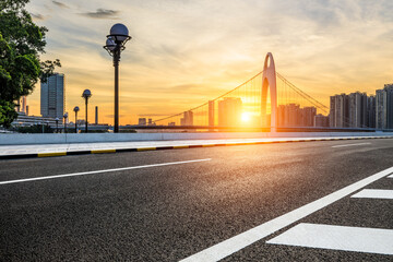 Asphalt road and modern city buildings scenery at sunset in Guangzhou