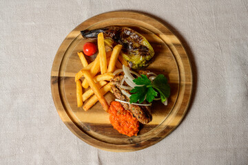 Cevapcici Balkan Style Meatballs with Ajvar Sauce, Onions, Parsley, French Fries and Grilled Pepper - obrazy, fototapety, plakaty