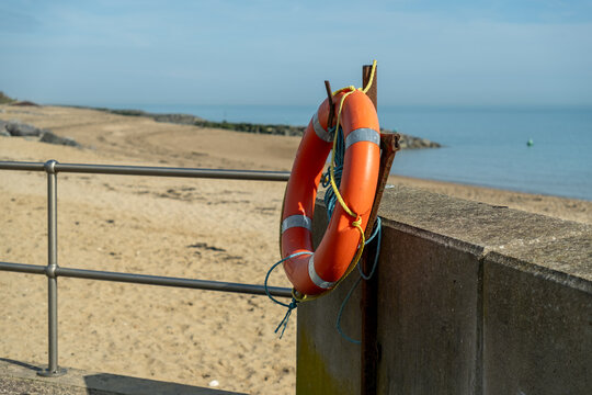 Orange life saver buoyancy ring on the promenade at Clacton beach