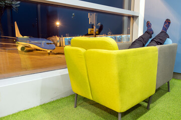 Moved chairs for the comfort of a sleeping passenger in an airport terminal at night