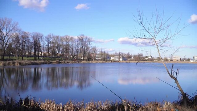 Moving towards beautiful blue lake Bubanj with a fishing rod on shore