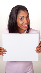 A Hispanic woman is holding a white sign in her hand in a 9X16 format, ideal for social media posting