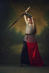 Commanding presence of female champion, her hair and skirt fiery red, standing ready with sharp...
