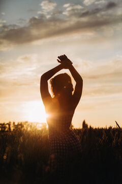 silhouette of a girl at sunset in the field