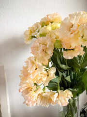 Photo of a delicate bouquet of white Eustoma flowers in vase on a white background