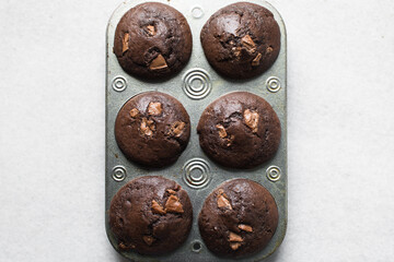 Overhead view of homemade dark chocolate muffins in a muffin pan