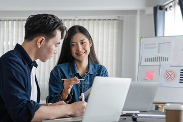 A team of accounting business people is having a brainstorming meeting to plan their work together in the company conference room.