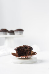 dark chocolate muffins on a white ceramic plate, chocolate muffins with copy space and white background