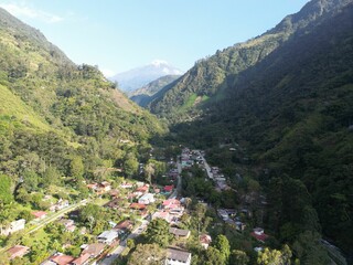 Fototapeta na wymiar Tranquil village nestled in the valley basking in the warm sunlight. Nevado del Tolima, Colombia.