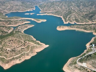 Drone shot of the Odelouca Reservoir surrounded by greenery in Algarve, Portugal