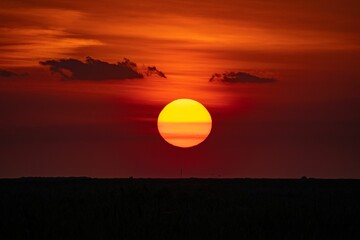 Vibrant image of a beautiful sunset in red colors in a tranquil landscape