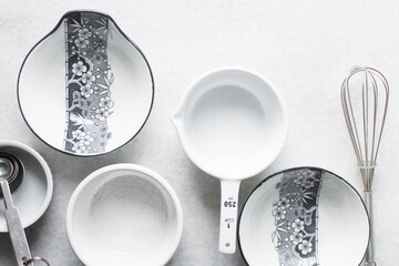 Overhead view of different plates dinnerware on a marble countertop, top view of white ramekin,...
