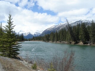 Tranquil lake surrounded by green trees and majestic mountains
