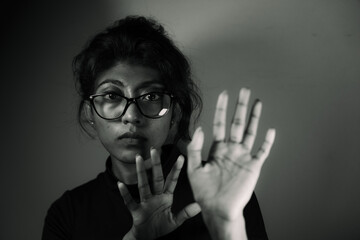 A woman with glasses and a hand on her face