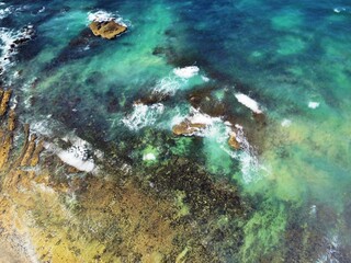 Picturesque shoreline with a rocky coastline and gentle waves lapping the shore