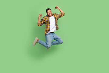 Full length photo of delighted nice person jumping raise fists success empty space isolated on...