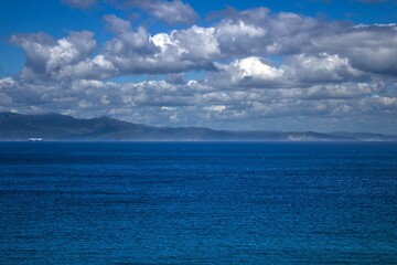Scenic view of the ocean with puffy clouds