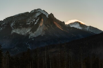 Stunning landscape featuring a majestic mountain range blanketed in snow