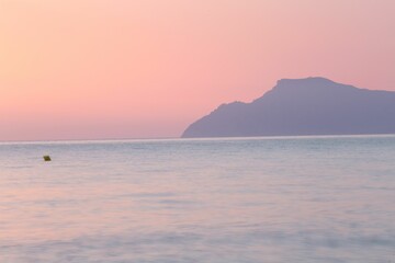 the ocean is calm at sunset
