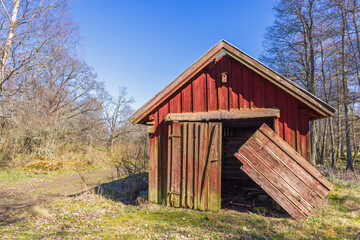 Old red shed with hanging doors in the countryside