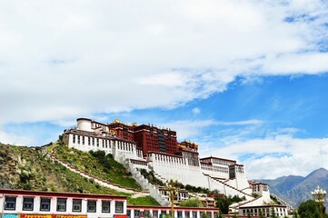Majestic Potala Palace on the peak of a hill on the background of the bright blue sky