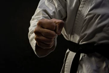 Foto op Canvas martial artists clenched fists, martial artist punch, a man punching with martial arts dress, kungfu, wrestling, fighting, self-defense, self-defence moves, car, hands, hand, business, woman, people,  © MH