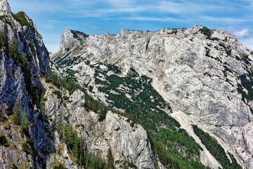Dramatic landscape featuring a towering mountain range surrounded by a vibrant blue sky