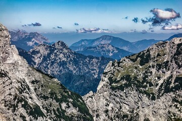 Scenic view of the majestic mountains, lush green forests with white clouds