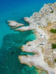 Aerial view of beach umbrellas at Praia I Focu against the sea in Calabria, Italy
