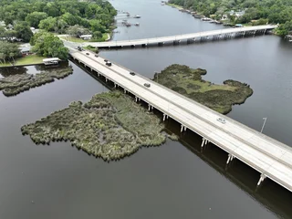 Fototapete Landwasserviadukt Bird eye view of a highway bridge connecting two land masses across a body of water