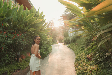 Beautiful asian woman walking and smiling in garden at resort - 773154062