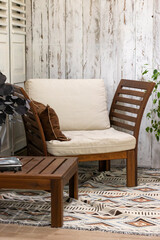 Wooden chair with pillow and cushions in the living room.