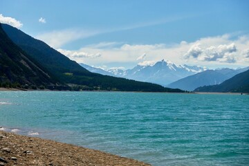 the water is calm as it comes from a shoreline and shore