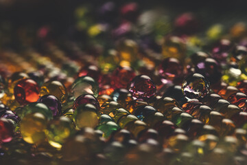 Colorful Water Beads staged in colorful light in close-up