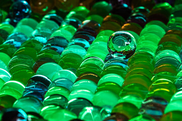 Green Water Beads staged in colorful light in close-up